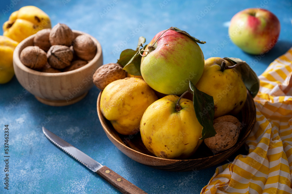Autumn fruits apples and quinces fruits on blue background, top view, lifestyle food Autumn fruits apples and quinces fruits on blue background, top view, lifestyle food