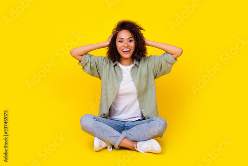 Full body photo of winsome young lady curly hair impressed good news win lottery wear trendy khaki look isolated on yellow color background © deagreez