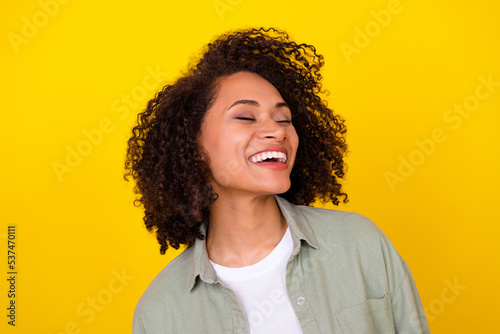 Photo of lovely wavy millennial brunette lady wear grey shirt isolated on vivid yellow color background