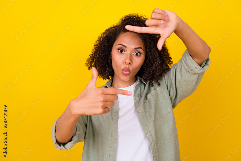 Photo of impressed wavy millennial lady do photo wear grey shirt isolated on yellow color background Photo of impressed wavy millennial lady do photo wear grey shirt isolated on yellow color background