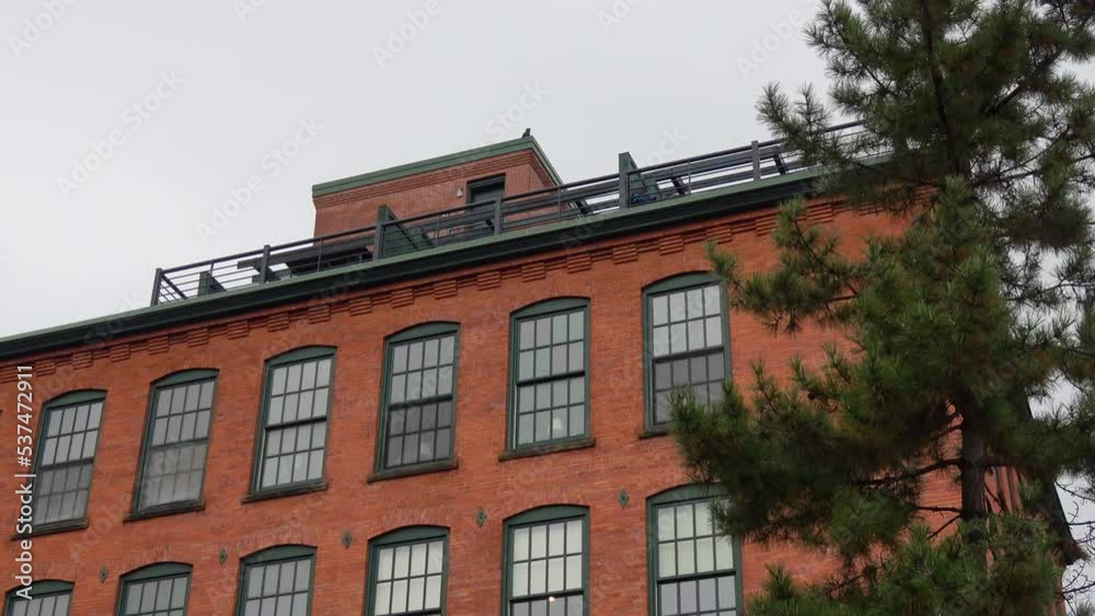 Exterior of red brick building with patio rooftop area, static 4K Exterior of red brick building with patio rooftop area, static 4K