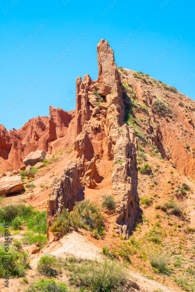 Ancient rocks made of red clay against the blue sky