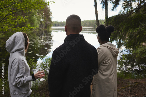 Friends looking at lake photo