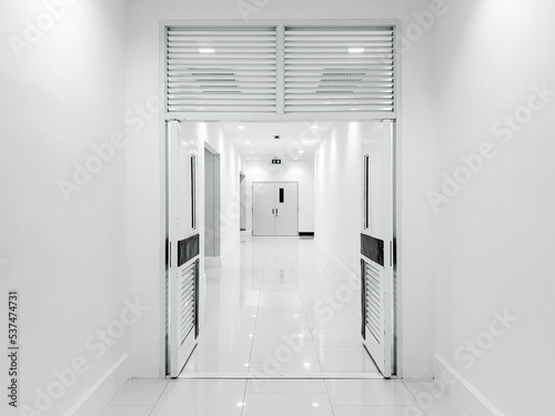 The door opened and empty corridor with white tone.