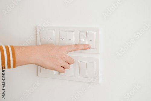 Finger touching switch for blinds on the wall