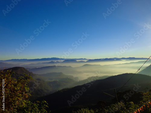 Beautiful Landscape of mountain layer in morning sun ray and winter fog at Sri Pada or Adam's Peak, Sri Lanka. photo