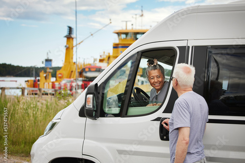 Senior couple getting in van