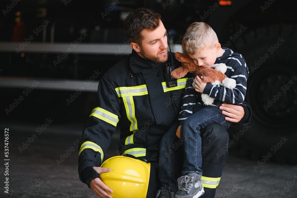 Firefighter holding child boy to save him in fire and smoke,Firemen rescue the boys from fire Firefighter holding child boy to save him in fire and smoke,Firemen rescue the boys from fire