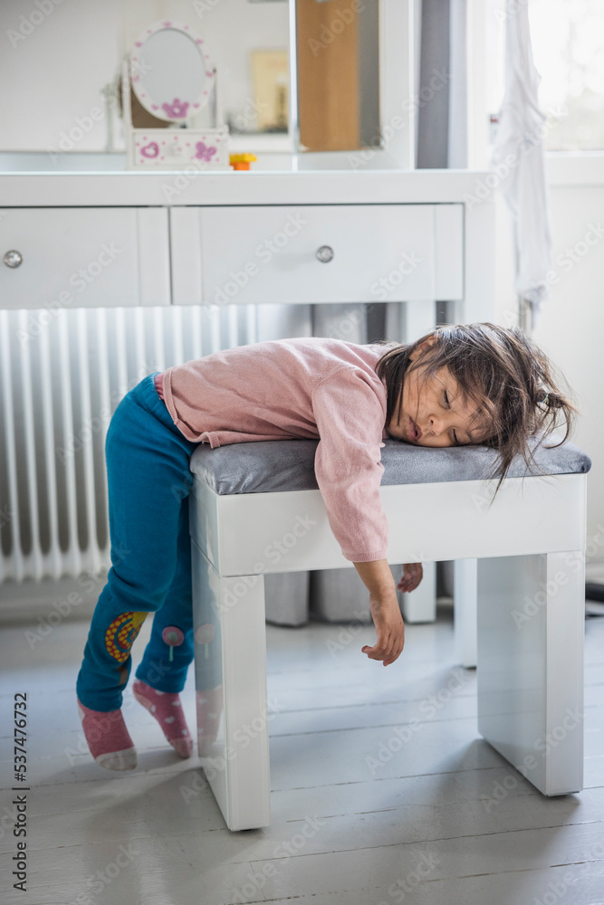 Tired girl sleeping on stool Tired girl sleeping on stool
