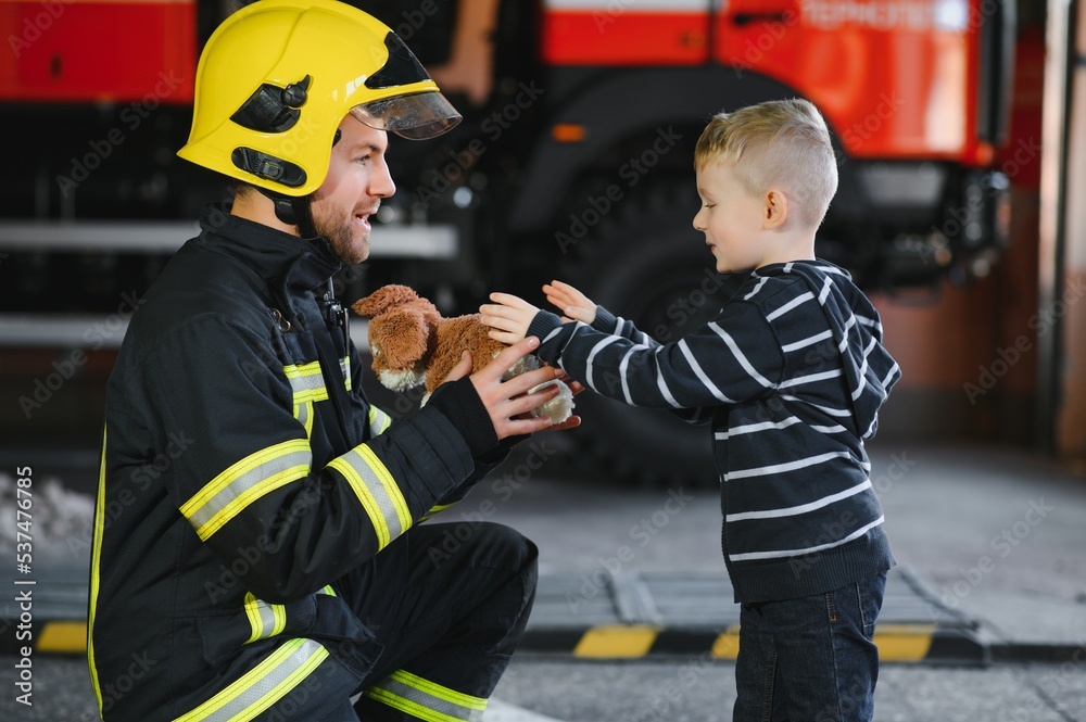 Firefighter holding child boy to save him in fire and smoke,Firemen rescue the boys from fire