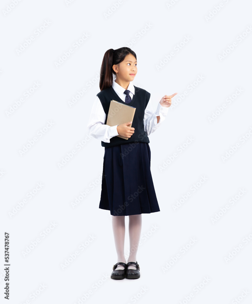 Junior school student in uniform posing on white background with full length. Back to school concept. Junior school student in uniform posing on white background with full length. Back to school concept.