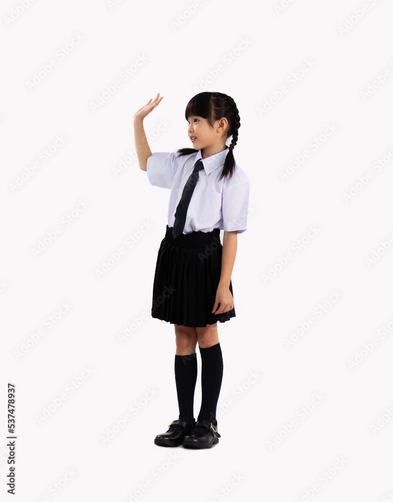 Junior school asian girl in british student uniform standing and posing hi and goodbye on white background. Back to school concept. Junior school asian girl in british student uniform standing and posing hi and goodbye on white background. Back to school concept.