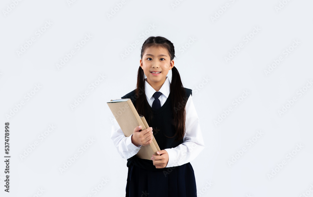 Junior school girl in student uniform holding book posing smiling on white background. Junior school girl in student uniform holding book posing smiling on white background.