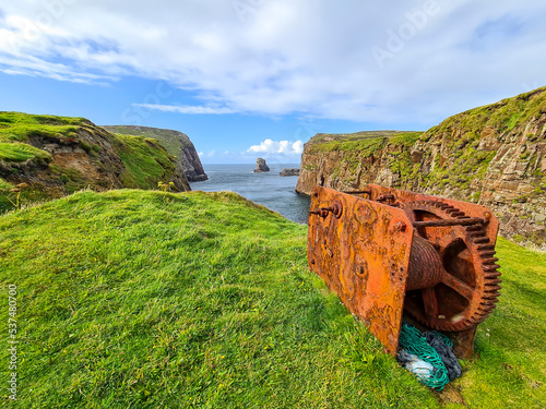 The cliffs and sea stacks at Port Challa on Tory Island, County Donegal, Ireland photo