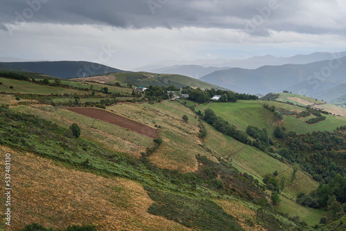 Meadows and mountains on a rainy day on the way up to O Cebreiro, Spain. French Way of Saint James.