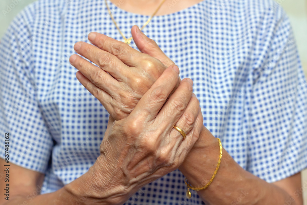 Holding hand adult woman with pain in muscles and joints,Symptoms of