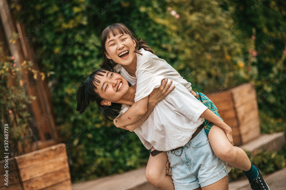 Two girls having fun in the park and looking excited