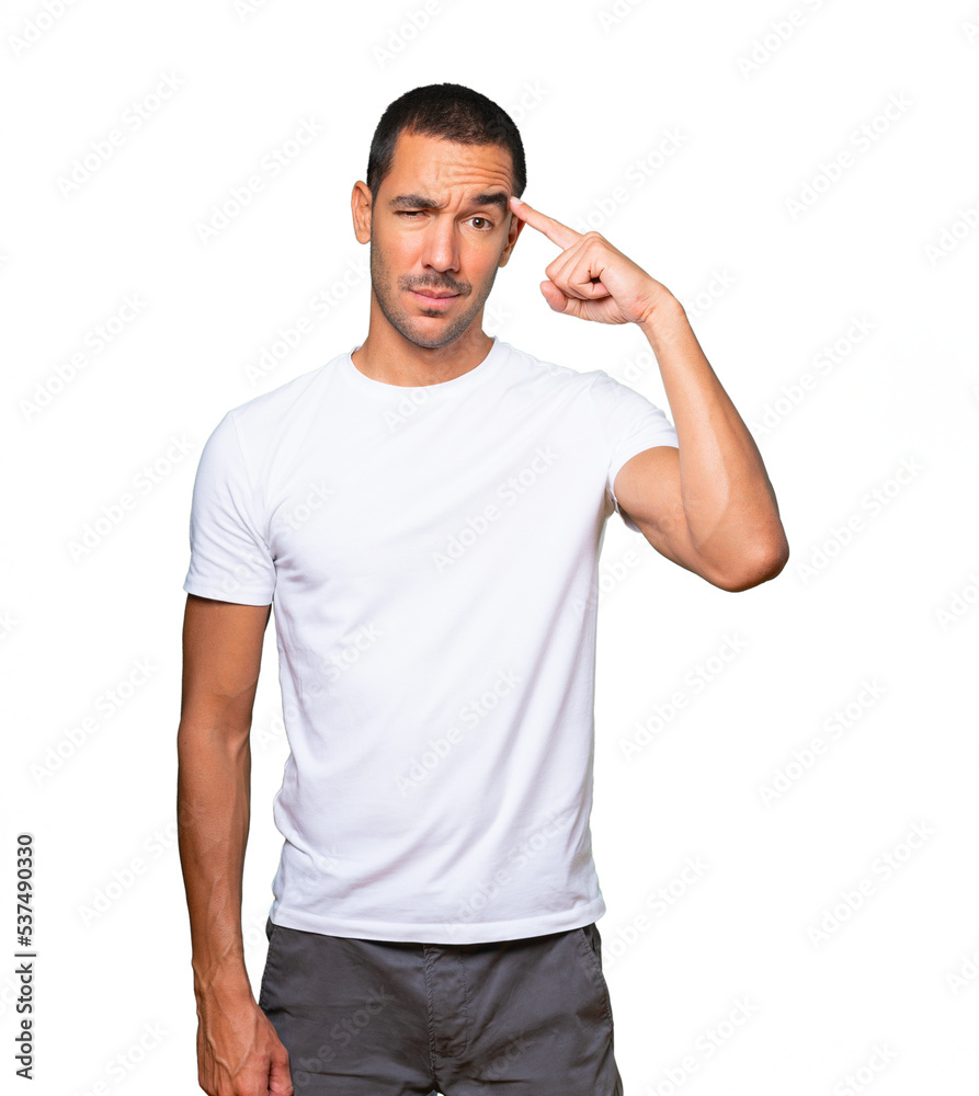 Serious young man doing a gesture of concentration Serious young man doing a gesture of concentration