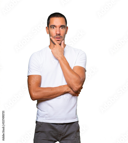 Concerned young man posing against background