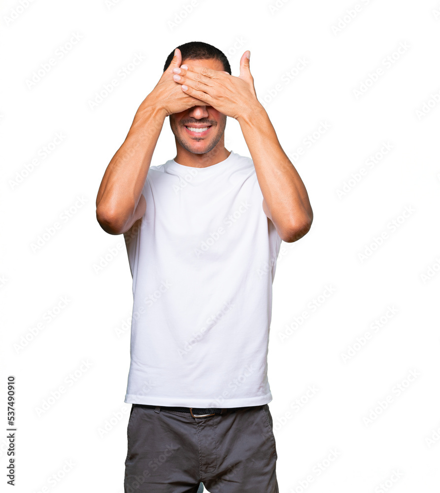 Fototapeta premium Young man covering his eyes with his hands