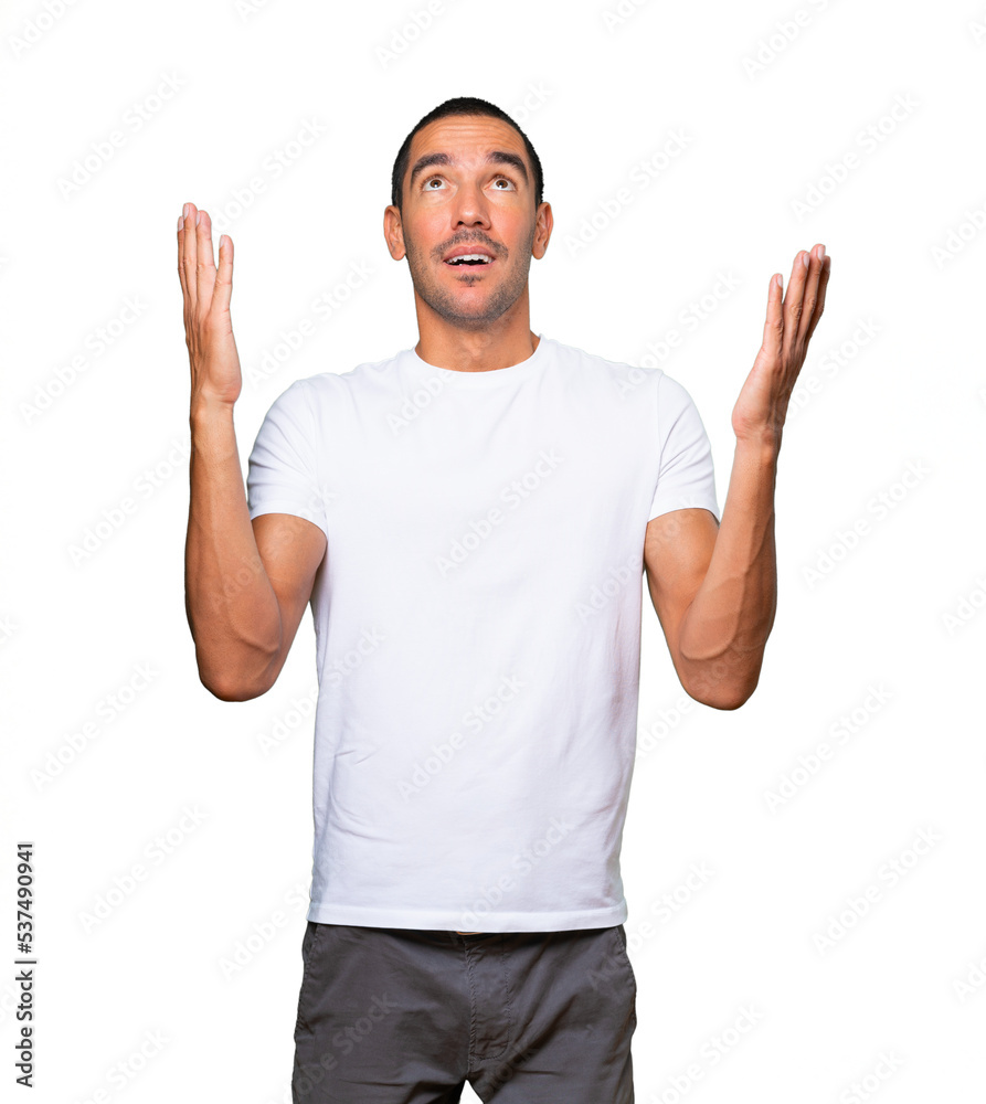 Astonished young man looking up Astonished young man looking up