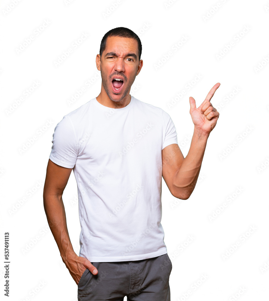 Cool young man pointing with his fingers Cool young man pointing with his fingers