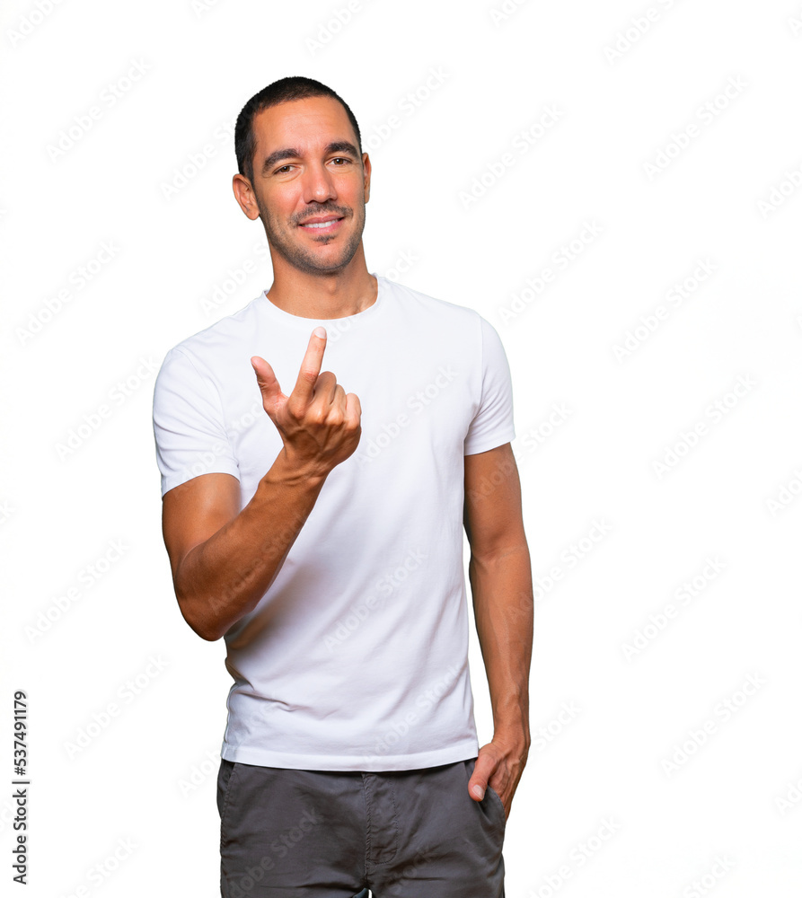 Happy young man doing a welcome gesture with his hand