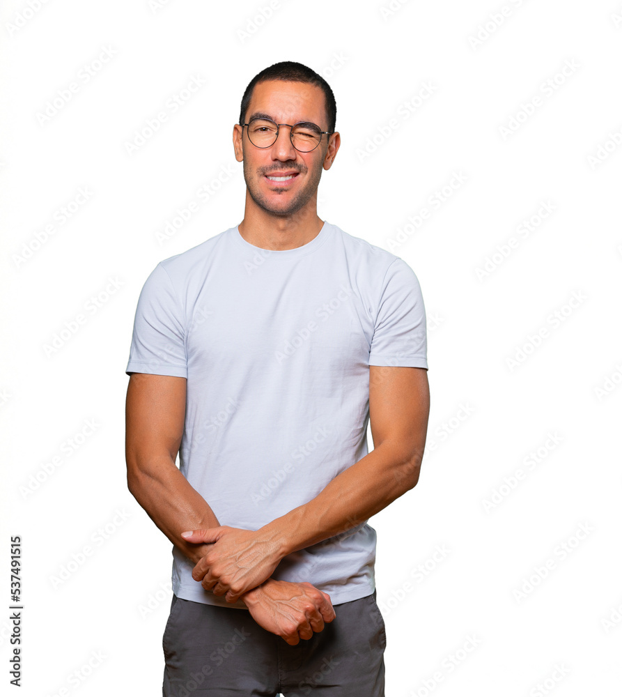 Fototapeta premium Friendly young man winking an eye
