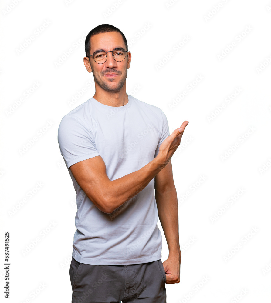 Fototapeta premium Friendly young man making a gesture of welcome