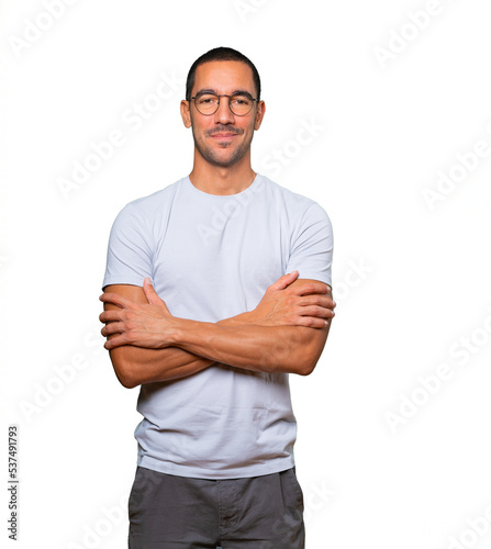 Satisfied young man with crossed arms gesture