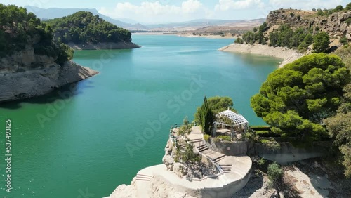 This clip of one of the beautiful Andalusian lakes shows how global warming has caused the water levels on our planet to receed. The normal level of the reservoir is clearly shown below the tree line.