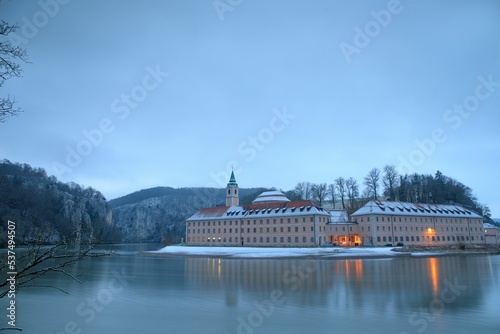 Weltenburg Abbey with a reflection on the Danube River at winter, Bavaria, Weltenburg, Germany photo