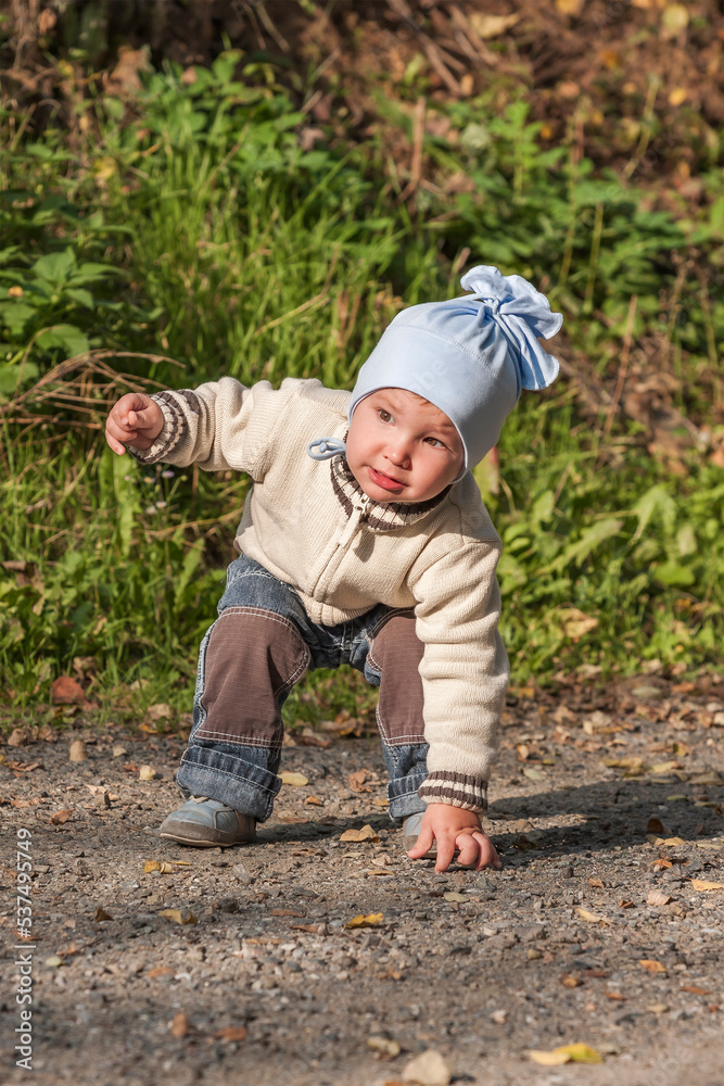 A little toddler is playing in the park. A little toddler is playing in the park.