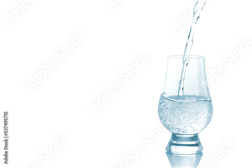 Clean drinking water pouring into wine glass isolated on white background.	