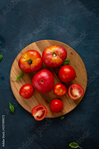 red tomatoes on wooden board in bowl food healthy cooking food top view