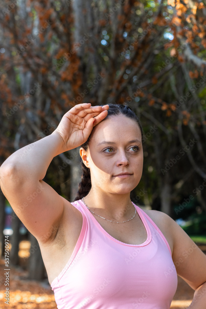 Close up of tired sporty girl with hand on forehead. Portrait of tired sporty woman with hand on forehead