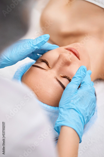 young beautiful woman receiving facial massage. spa