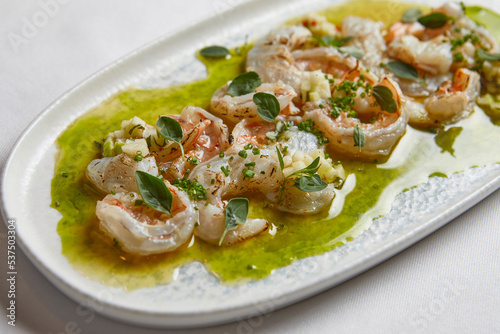 shrimps with sauce on a plate close-up