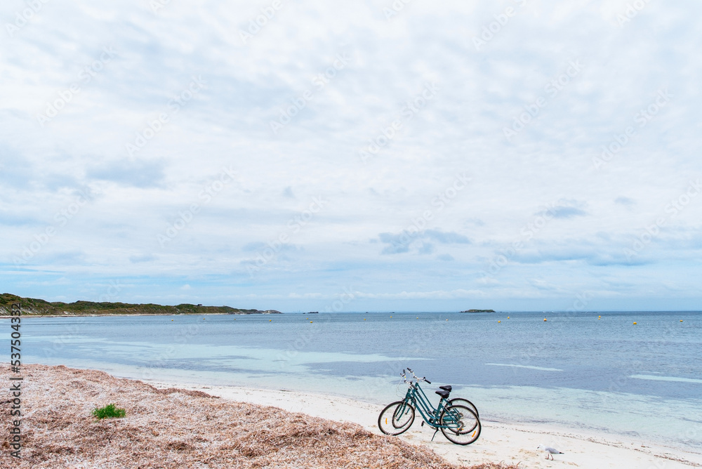 Two bicycles parked on a beach on Rottnest Island, Western Australia. Bike rental for tourists. Scenic view