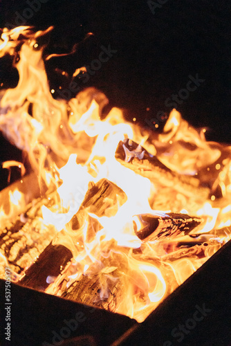 Big flame from bonfire on black background.