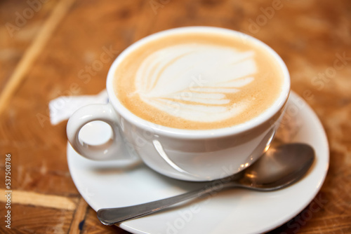 A cup of coffee or Latte with heart pattern in a white cup