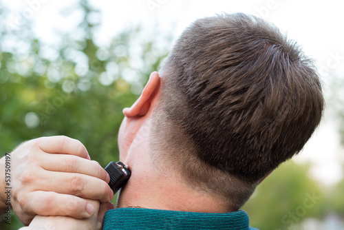 The criminal hits the man in the neck with a stun gun.