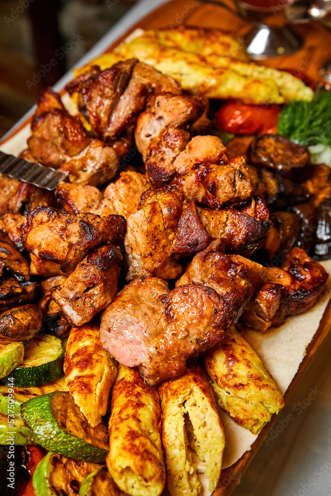 Shish kebab with grilled vegetables, lavash and sauces. Close-up, selective focus