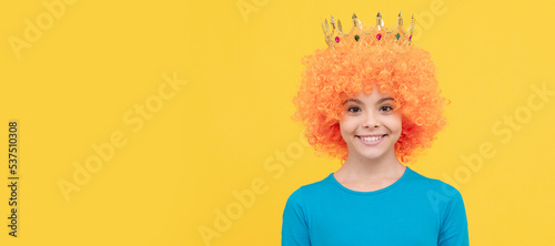 girls birthday party. happy funny kid in curly wig and crown. imagine herself a queen. Funny teenager child in wig, party poster. Banner header, copy space.