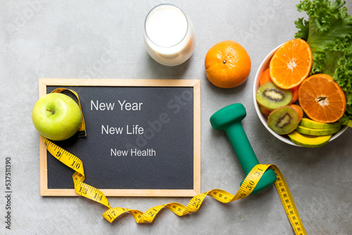 New Year for New Changes Healthy 2023.  Fresh vegetable fruits and healthy food for sport equipment for women diet slimming weight loss.  Healthy and Holiday Concept