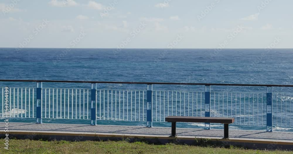Stone bench and the blue sea at summer time