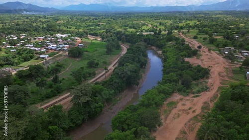 Aerial view showing new build fence at river in Dajabon Province between Haiti and Dominican Republic photo