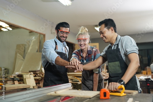 Contemporary Carpenter Working, Portrait of modern carpenter making wood furniture while working in joinery lit by sunlight with factory background on small business concept, copy space