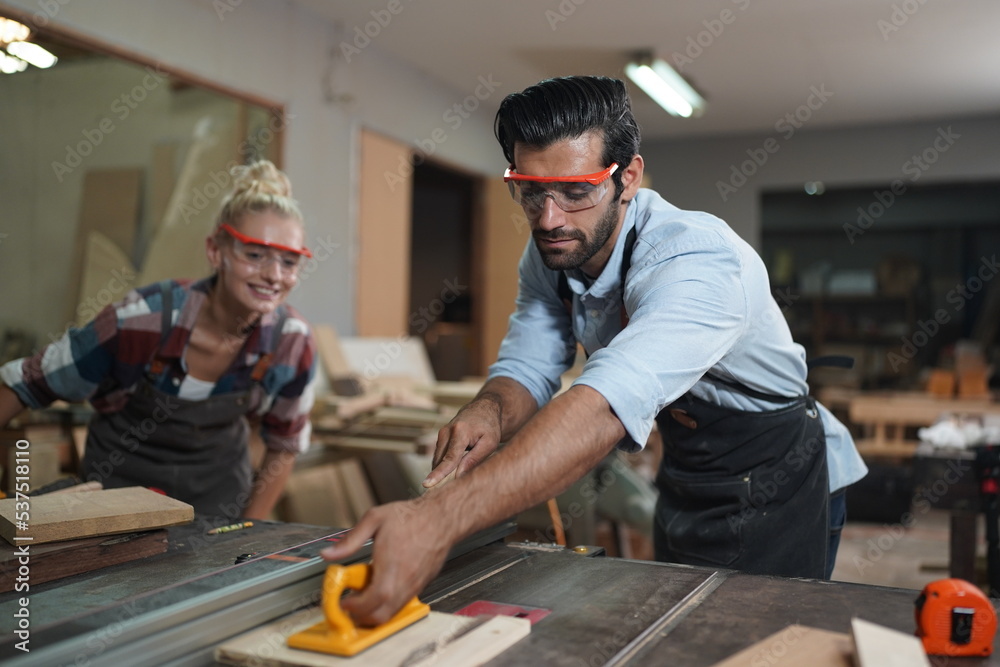 Contemporary Carpenter Working, Portrait of modern carpenter making wood furniture while working in joinery lit by sunlight with factory background on small business concept, copy space Contemporary Carpenter Working, Portrait of modern carpenter making wood furniture while working in joinery lit by sunlight with factory background on small business concept, copy space