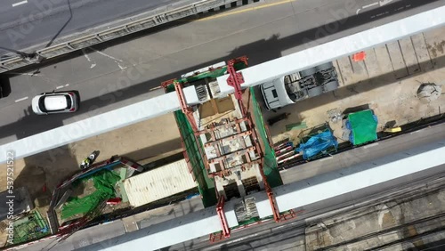 Bangkok urban Mass Transit Project (Pink Line Monorail). Aerial top view Construction of pink line monorail rail transit line in progress.Guide way beam, Light rail transit, construction machinery.	 photo